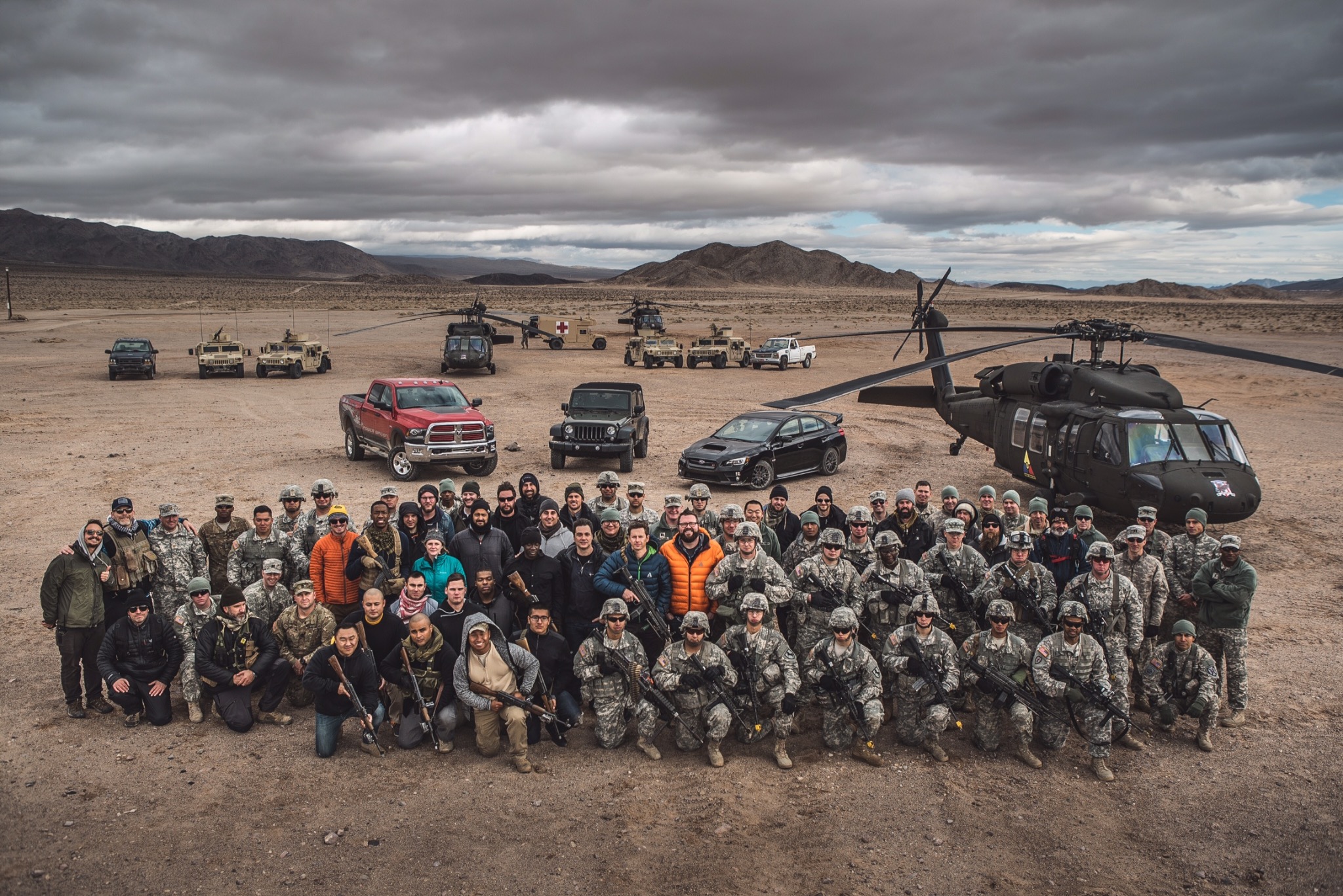 Large Top Gear USA crew and military group posing at Fort Irwin with vehicles and helicopters